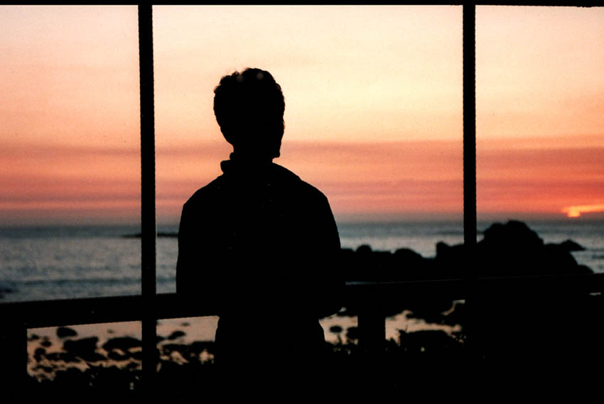 photo of sunset view through window of battery point beachhouse